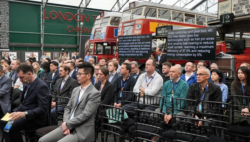 Guests gathering around the displayed double-decker bus.